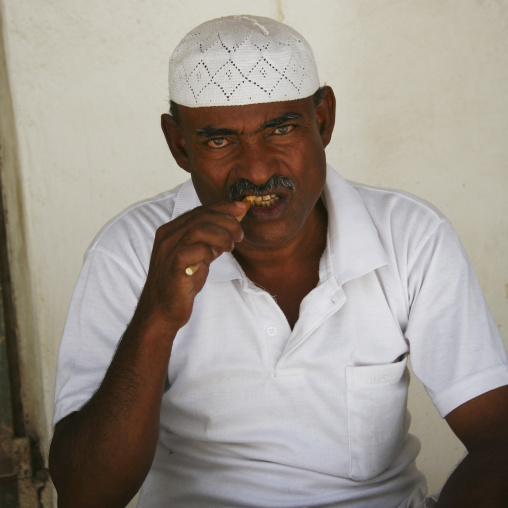 Yemenni Man With White Taqiyah Chewing A Toothbrush Stick, Tarim, Yemen