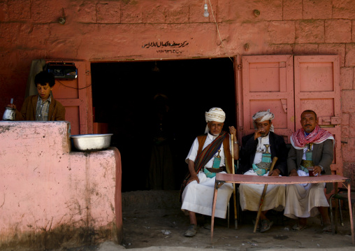 Three Men Sitting In Front Of A Table At A The Terrace Of A Coffee Shop, Amran, Yemen