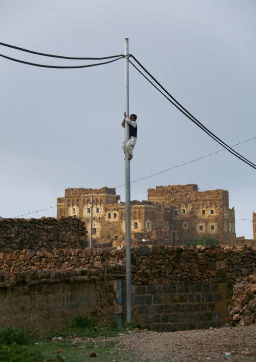 Boy Climbing On A Telephone Pole, Shahara, Yemen