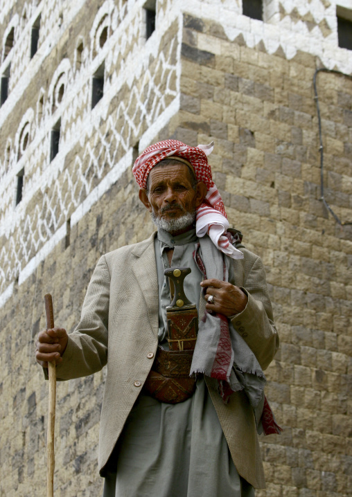 Old Man In Turban Posing Proudly In Front Of A Painted House In Al Hajjara, Yemen