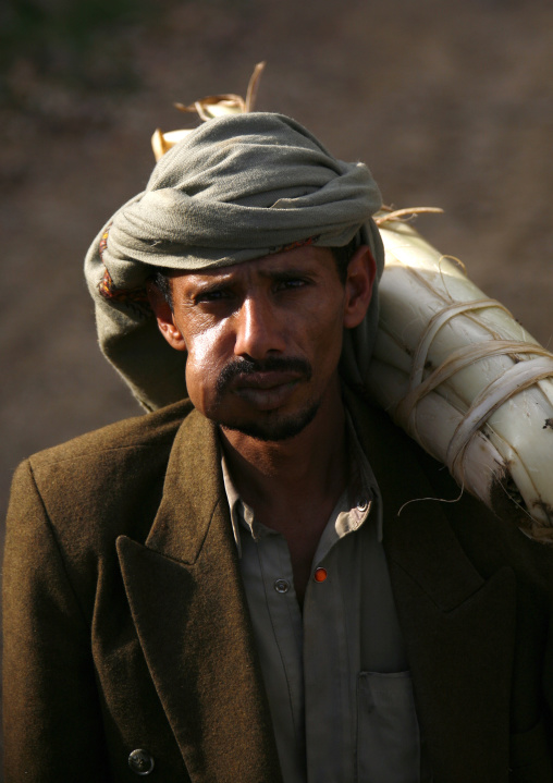 Khat Chewer Carring A Package On His Shoulder Under The Sun Light, Shahara, Yemen