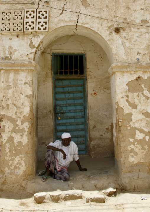 Man With White Taqiyah Sitting On The Ground And Looking At Camera, Tarim, Yemen
