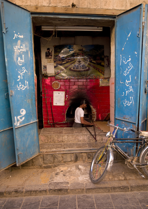 Baker Working In Front Of His Bright Red Oven Sanaa, Yemen