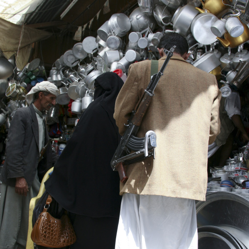 Man Carrying A Kalashnikov In Front Of A Crockery Shop, Sanaa Souq, Yemen