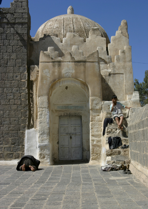 Man Praying And Boy Sitting On Stairs In Dhamar, Yemen