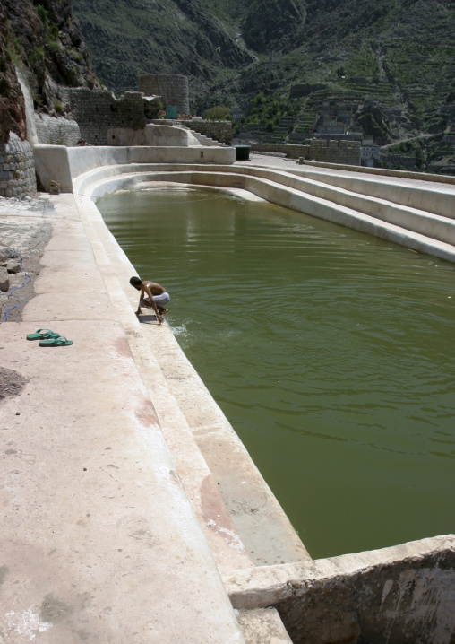 Man Taking A Bath In The  Water Cistern In The Mountain Village Of Hababa, Yemen
