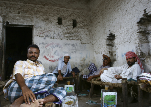 Men Resting And Drinking On Wooden Banks In A House, Zabid, Yemen
