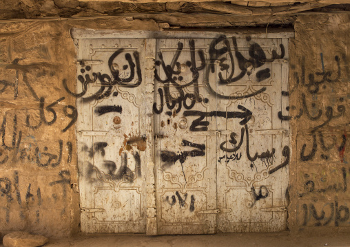 Closed door of a shop with graffitti, Amran Governorate, Amran, Yemen