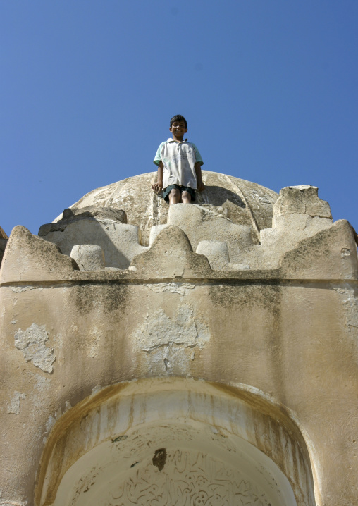 Yemeni boy standing on a mosque, Dhamar Governate, Dhamar, Yemen
