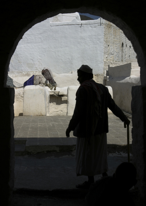 Yemeni man going inside the white Mosque of Ahmed Ibn Alwan, Taiz Governorate, Yafrus, Yemen