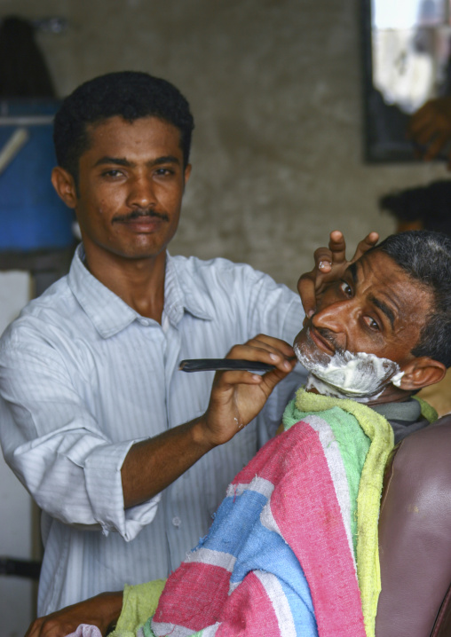Yemeni man in a barber shop, Al Hudaydah Governorate, Zabid, Yemen