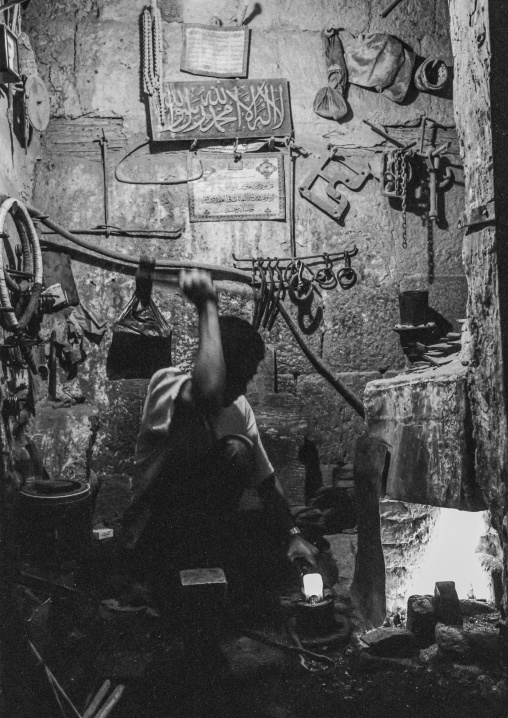 Yemeni blacksmith working in his workshop, Amanat Al-Asemah, Sanaa, Yemen