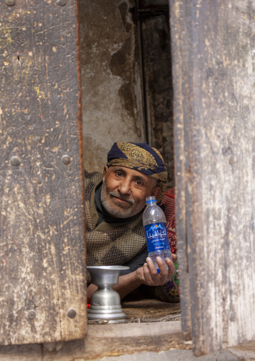 Portrait of a yemeni man resting in his small shop, Amanat Al-Asemah, Sanaa, Yemen