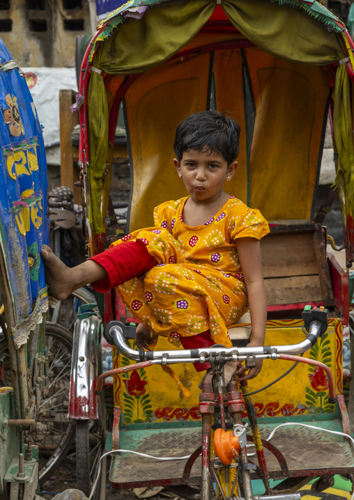 Bangladeshi girl sit on a parked rickshaw, Dhaka Division, Dhaka, Bangladesh