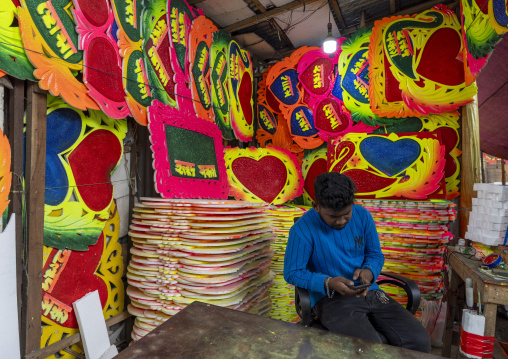 Bangladeshi man selling polystyrene decorations for weddings, Dhaka Division, Dhaka, Bangladesh