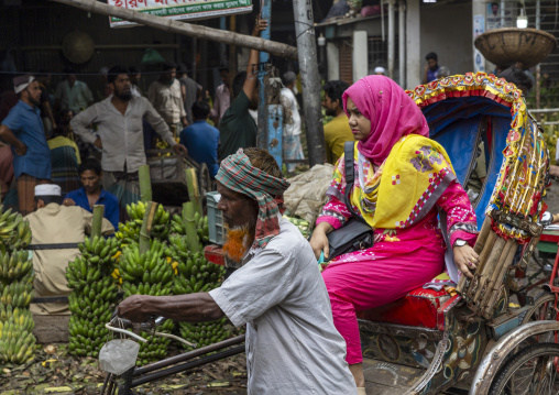 Woman sit in a rickshaw at vegetables and fruits morning market, Dhaka Division, Dhaka, Bangladesh