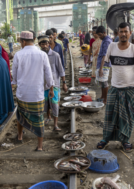Bangladeshi men selling fishes along the railway track in Kawran bazar, Dhaka Division, Dhaka, Bangladesh