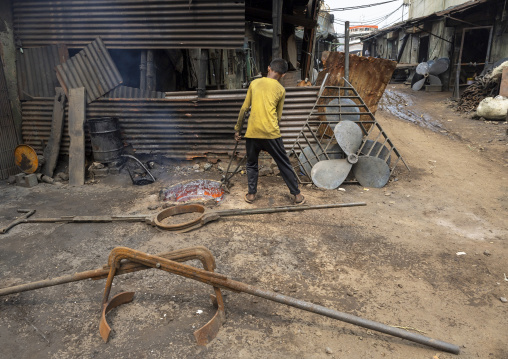 Bangladeshi boy melting steel at Dhaka Shipyard, Dhaka Division, Keraniganj, Bangladesh