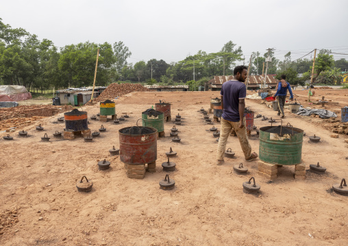Worker on the roof of the giant oven at a brick factory, Sylhet Division, Bahubal, Bangladesh