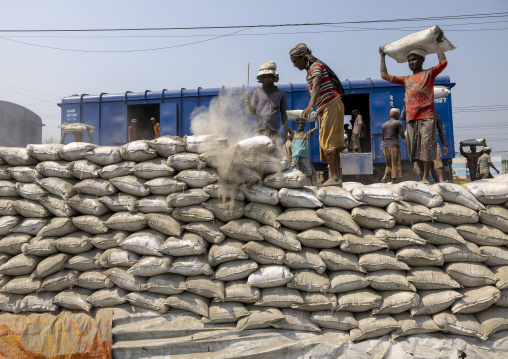 Bangladeshi workers unloading cement bags from a train, Khulna Division, Abhaynagar, Bangladesh