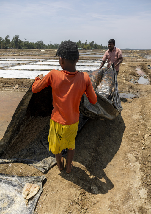 Bangladeshi men working in a salt field, Chittagong Division, Maheshkhali, Bangladesh