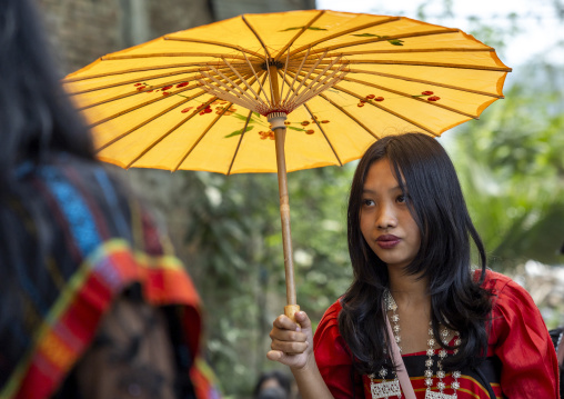 Chakma woman in traditional clothing with umbrella celebrating Biju festival, Chittagong Division, Kawkhali, Bangladesh