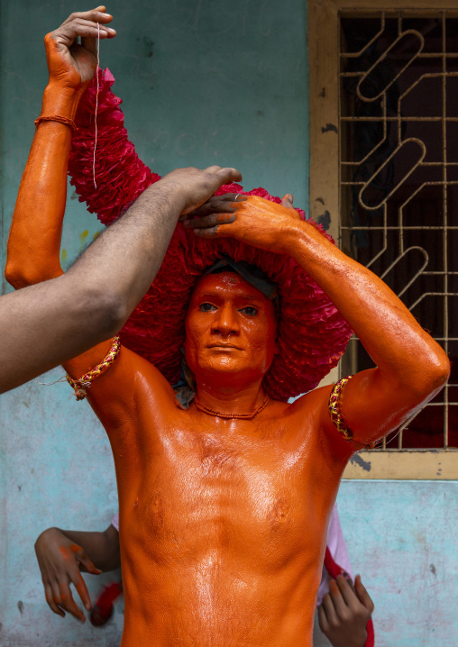 Portrait of a Hindu devotee covered with orange color in Lal Kach festival, Dhaka Division, Munshiganj Sadar, Bangladesh