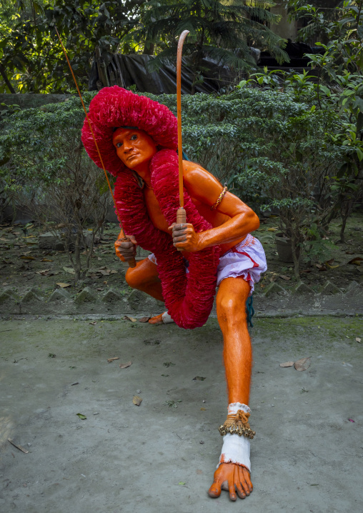 Hindu devotee with a sword covered with orange color at Lal Kach festival, Dhaka Division, Munshiganj Sadar, Bangladesh