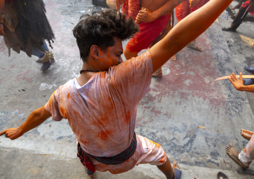 Portrait of a Hindu devotee covered with orange color in Lal Kach festival, Dhaka Division, Munshiganj Sadar, Bangladesh