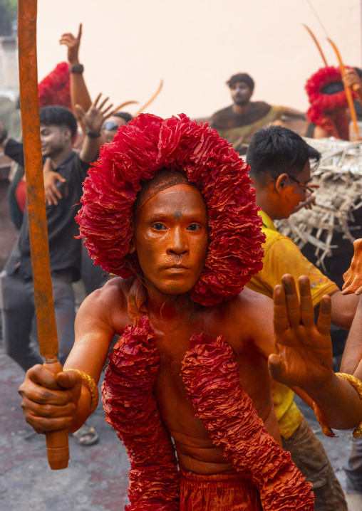 Hindu devotee with a sword covered with orange color at Lal Kach festival, Dhaka Division, Munshiganj Sadar, Bangladesh