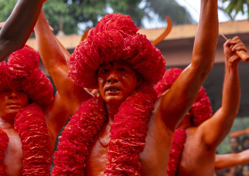 Portrait of a Hindu devotee covered with orange color in Lal Kach festival, Dhaka Division, Munshiganj Sadar, Bangladesh