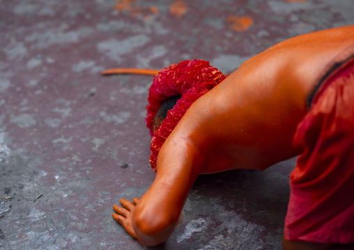 Hindu devotee covered with orange color praying in  Lal Kach festival, Dhaka Division, Munshiganj Sadar, Bangladesh