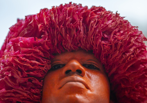 Portrait of a Hindu devotee covered with orange color in Lal Kach festival, Dhaka Division, Munshiganj Sadar, Bangladesh