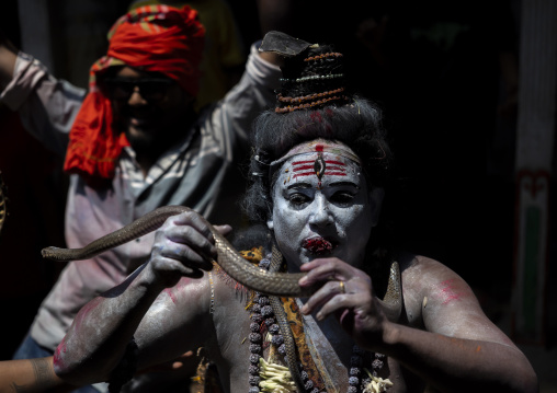 Lord Shiva with a snake during a procession at Lal Kach festival, Dhaka Division, Munshiganj, Bangladesh