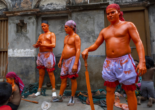Dressing of Hindu devotees covered with orange color at Lal Kach festival, Dhaka Division, Munshiganj, Bangladesh