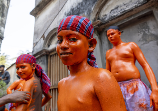 Young hindu devotees covered with orange color at Lal Kach festival, Dhaka Division, Munshiganj, Bangladesh