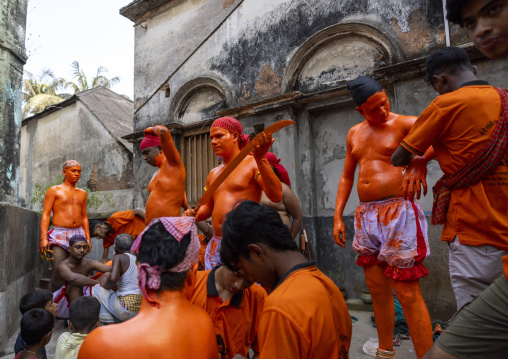 Hindu devotees with swords covered with orange color at Lal Kach festival, Dhaka Division, Munshiganj, Bangladesh