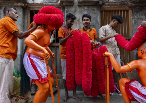 Dressing of a Hindu devotee covered with orange color at Lal Kach festival, Dhaka Division, Munshiganj, Bangladesh