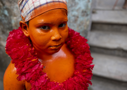 Young hindu devotee covered with orange color at Lal Kach festival, Dhaka Division, Munshiganj, Bangladesh
