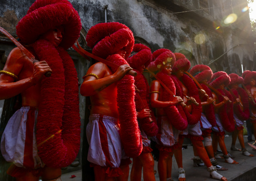 Hindu devotees with swords in orange color in line at Lal Kach festival, Dhaka Division, Munshiganj, Bangladesh