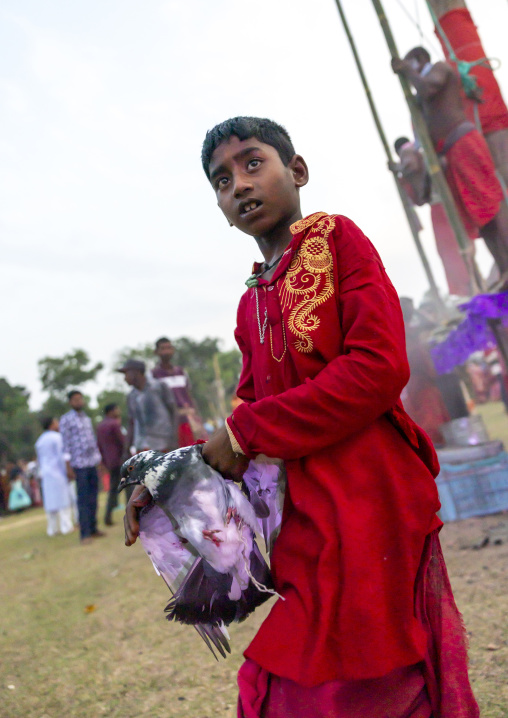Boy with a pigeon during Charak Puja hindu festival, Sylhet Division, Kamalganj, Bangladesh