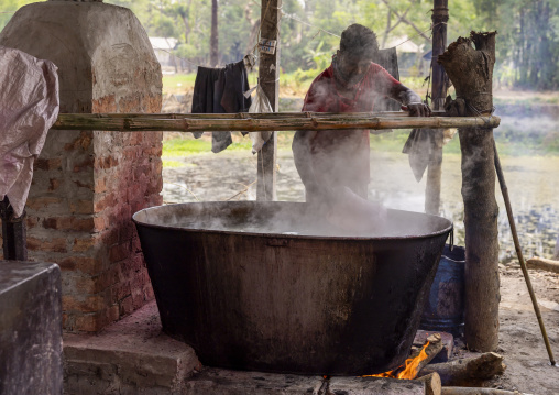 Bangladeshi man dyeing fabrics in a batik factory, Chittagong Division, Comilla, Bangladesh