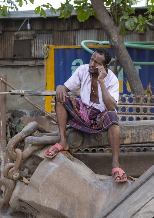 Bangladeshi man calling on his phone in the street, Chittagong Division, Chittagong, Bangladesh