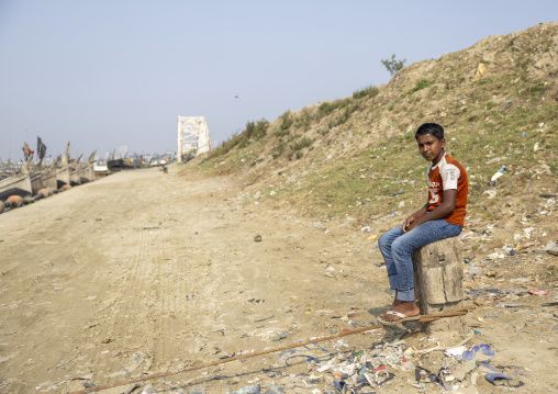 Bangladeshi boy sit in the harbor, Chittagong Division, Chittagong, Bangladesh