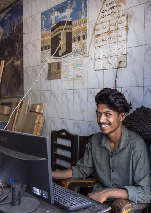Bangladeshi young man using a computer in an internet cafe, Chittagong Division, Bandarban, Bangladesh