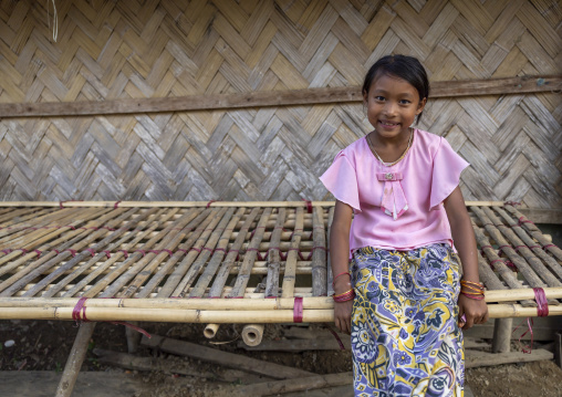 Portrait of a Marma ethnic group girl sit on a bamboo bed, Chittagong Division, Rowangchhari, Bangladesh