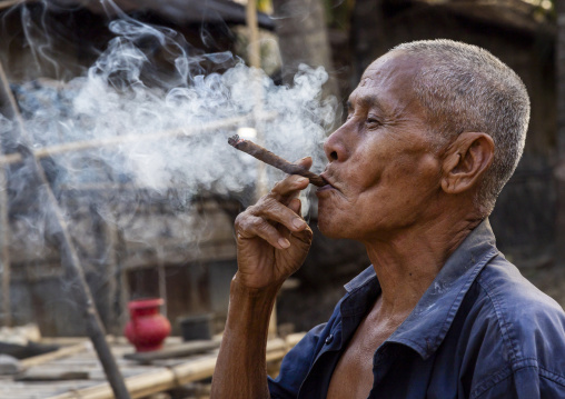 Marma old man smoking a cigar, Chittagong Division, Rowangchhari, Bangladesh