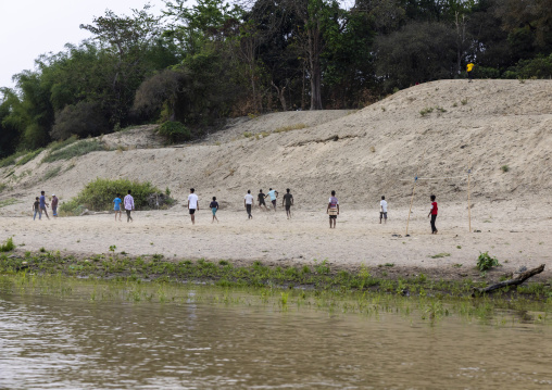 Marma ethnic group men playing football on the bank of the river, Chittagong Division, Rowangchhari, Bangladesh