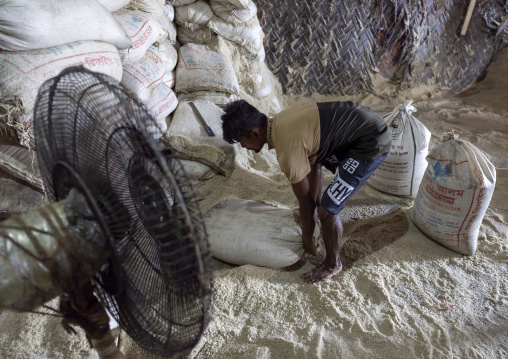 Bangladeshi man working in a salt factory, Chittagong Division, Chittagong, Bangladesh
