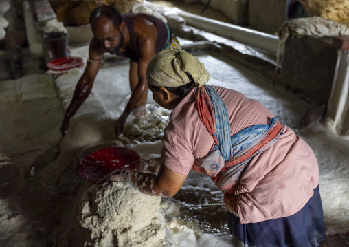 Bangladeshi workers washing salt in water in a factory, Chittagong Division, Chittagong, Bangladesh